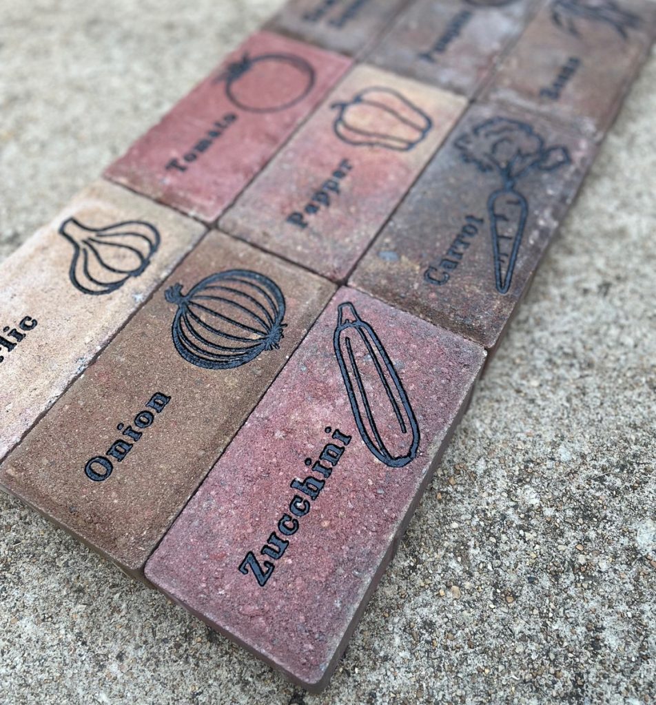 Concrete pavers engraved with image and name of various vegetables