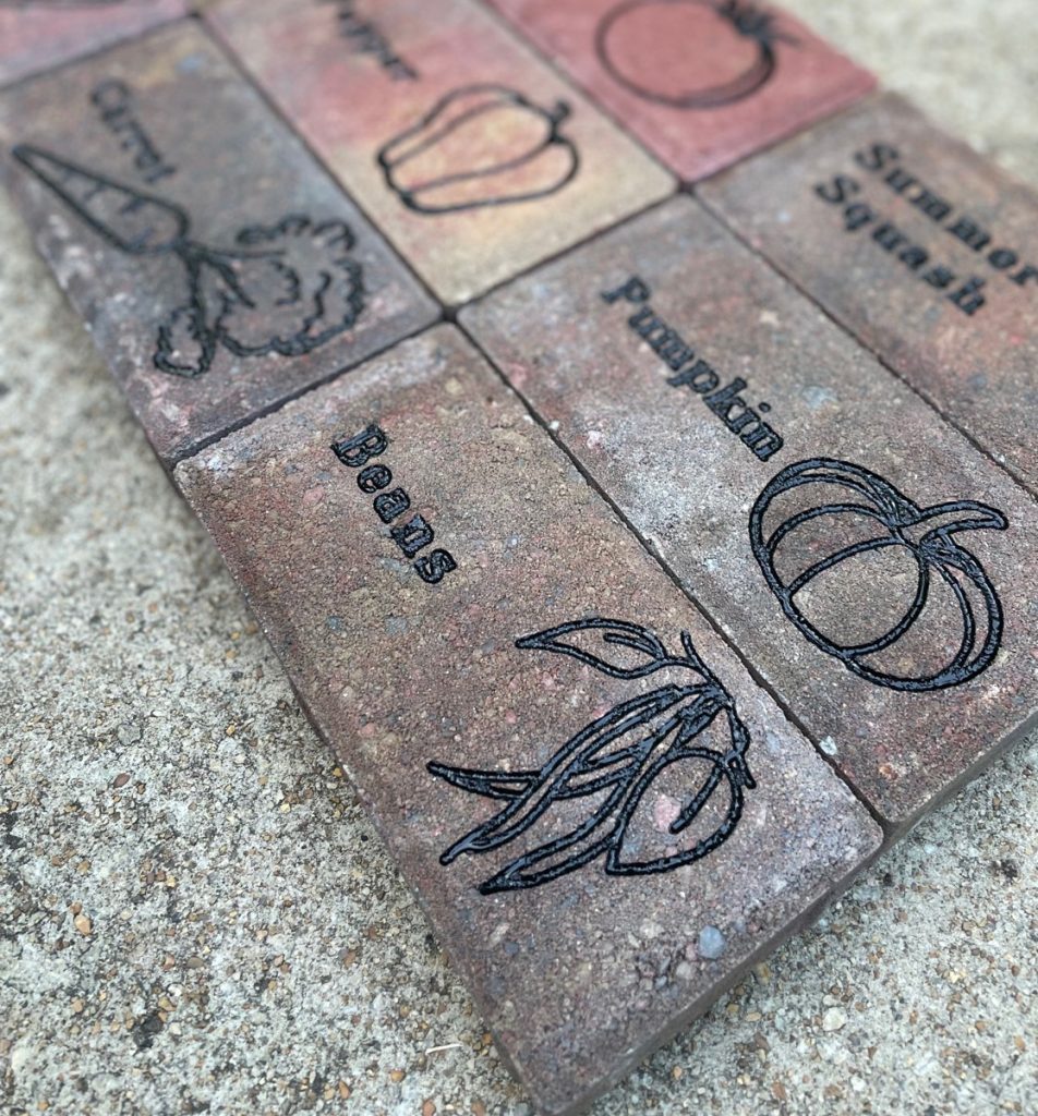 Concrete pavers engraved with image and name of various vegetables