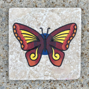 Marble tile with a colorful butterfly against a blue circle engraved and painted on it.