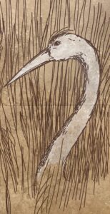 Travertine tiles with crane's head and neck above the grass engraved on it.