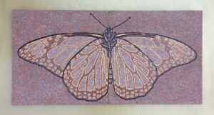 Two red granite tiles with monarch butterfly image engraved and painted on them.