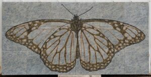 Eightteen granite tiles engrave with one large butterfly image across all of the tiles