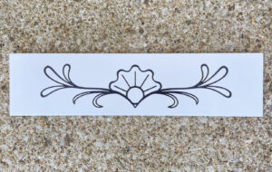 4in. x 16in. engraved white subway tile White subway tile with decorative flower engraved and painted black on it.