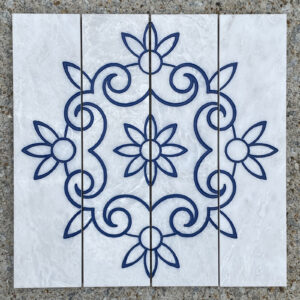 4 - 3in. x 12in. engraved white marble tiles, blue lacquer Four white marble tiles with old fashioned stencil design engraved and painted blue on them to make a single image.