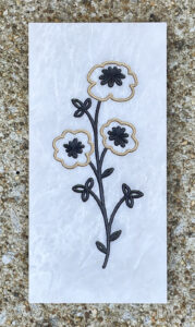 4in. x 8in. engraved white marble tile White marble tile with stylized flowers and leaves engraved and painted on it.
