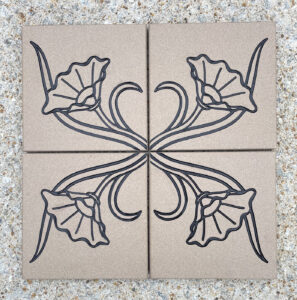 4 - 6in. x 6in. engraved gray quarry tiles, black lacquer Four gray quarry tiles with a flower design engraved and painted black placed together to make a single image.